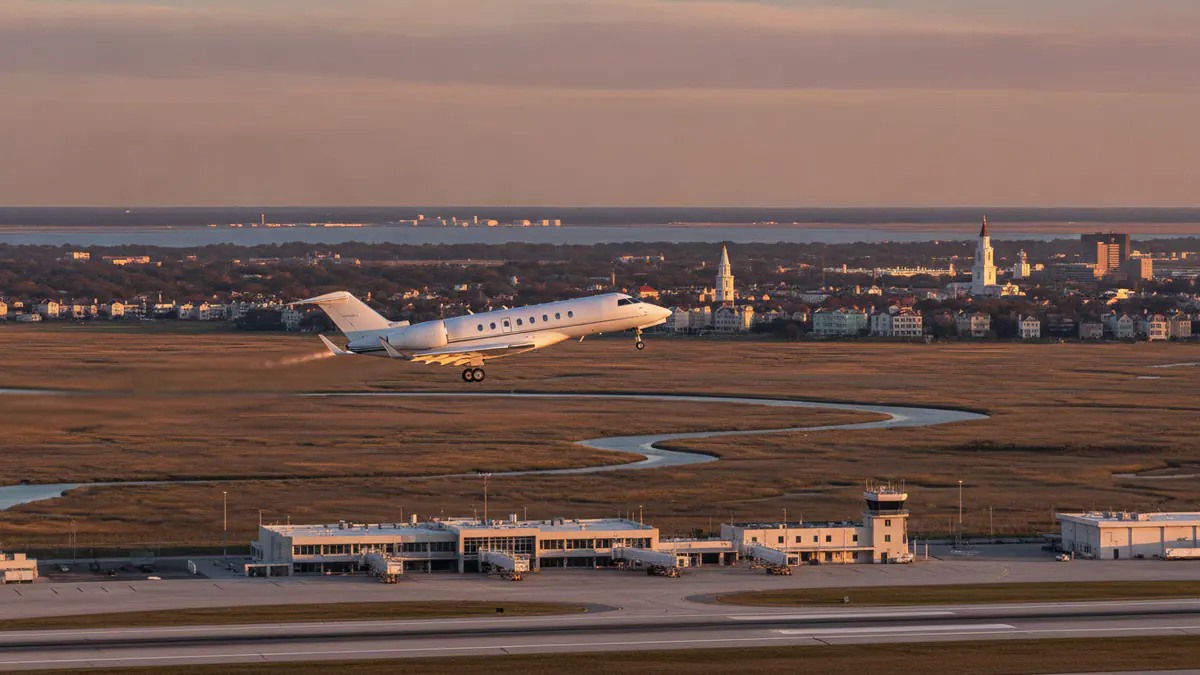 Charleston private jet charter Charleston private jet charter: business jet taking off with Charleston in the background