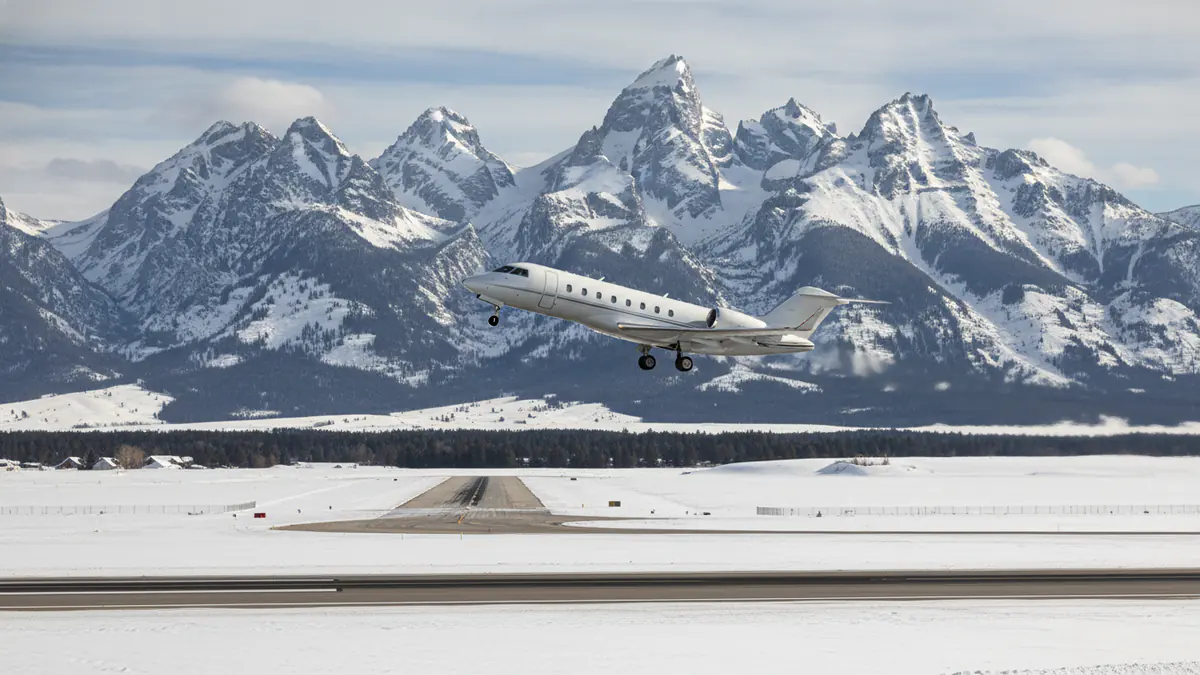 Jackson Hole private jets: business jet taking off with Jackson Hole in the background