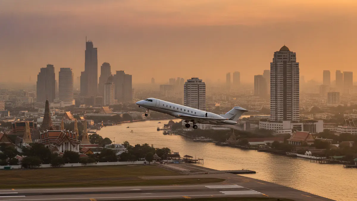 Private jet charter Bangkok Private jet charter Bangkok: business jet taking off with Bangkok in the background