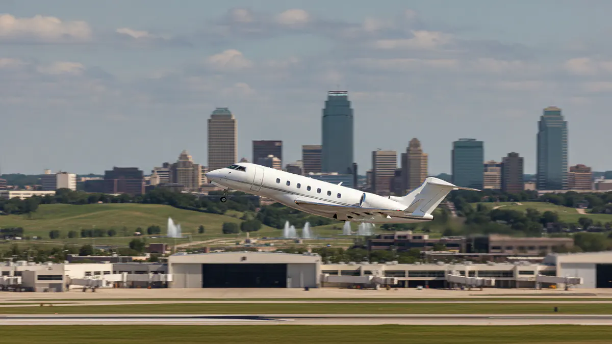 Private jet charter Kansas City: business jet taking off with Kansas City in the background