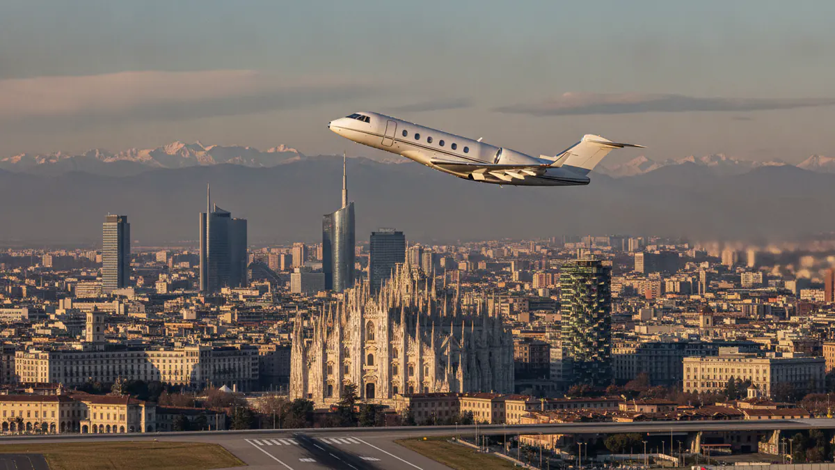 Private jet charter Milan: business jet taking off with Milan in the background