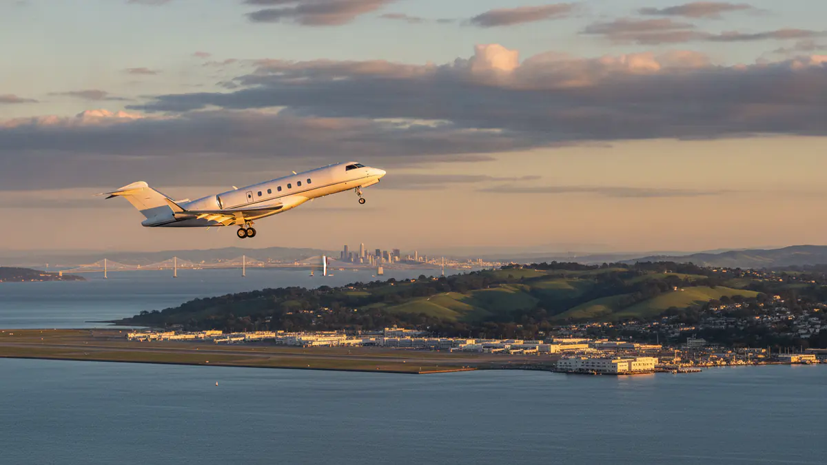 Private jet charter Oakland Private jet charter Oakland: business jet taking off with Oakland in the background