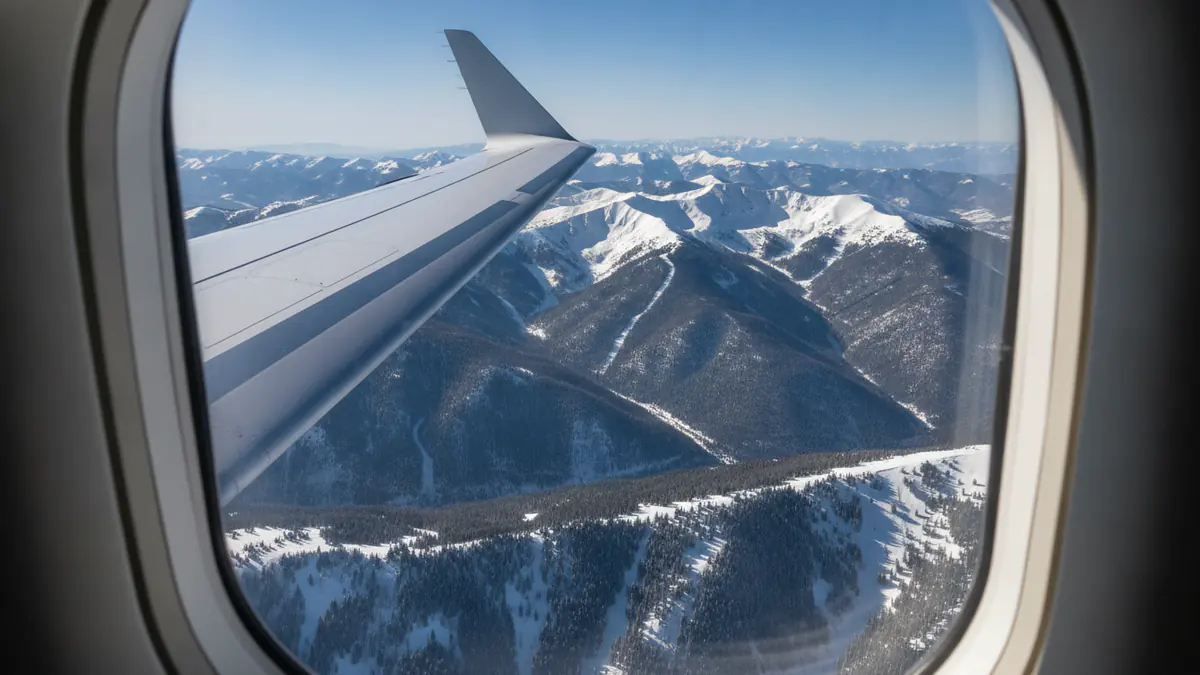 Private jet London to Aspen: cabin window view on approach to Aspen