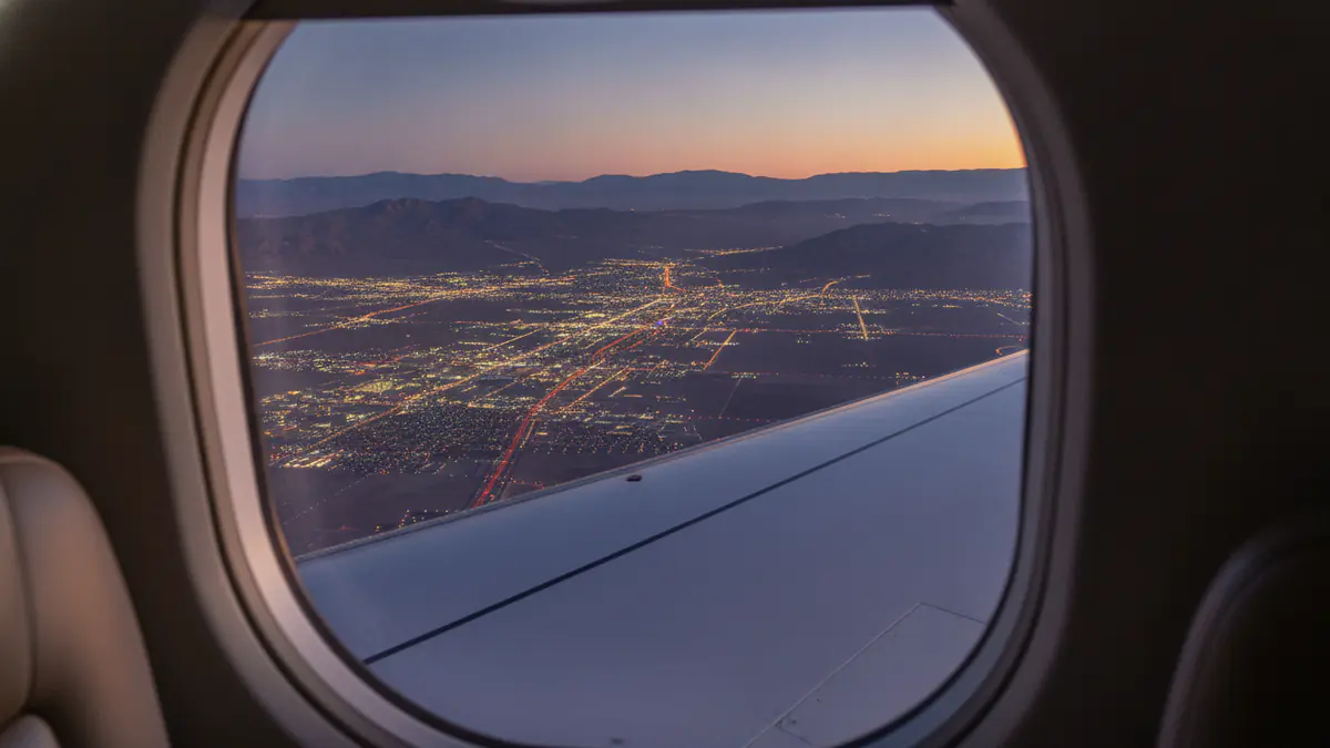 Private jet New York to Las Vegas: cabin window view on approach to Las Vegas