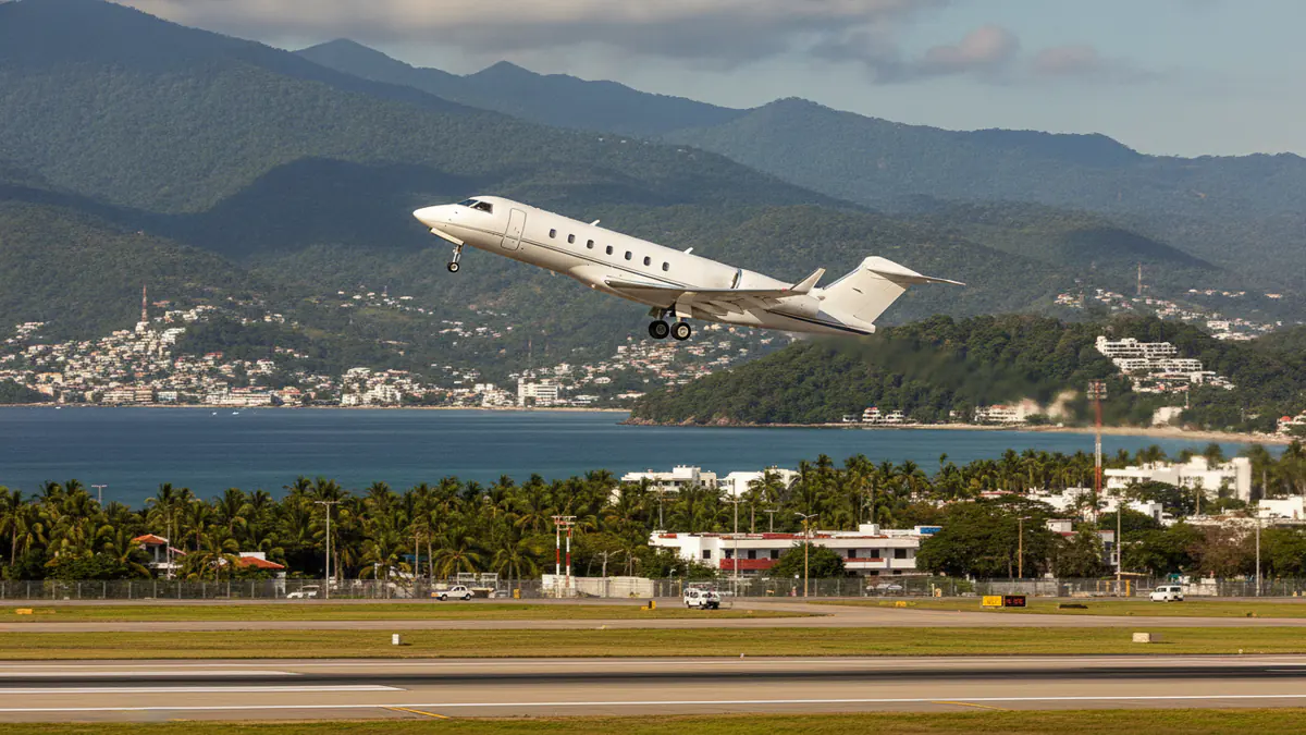 Private jet Puerto Vallarta Private jet Puerto Vallarta: business jet taking off with Puerto Vallarta in the background