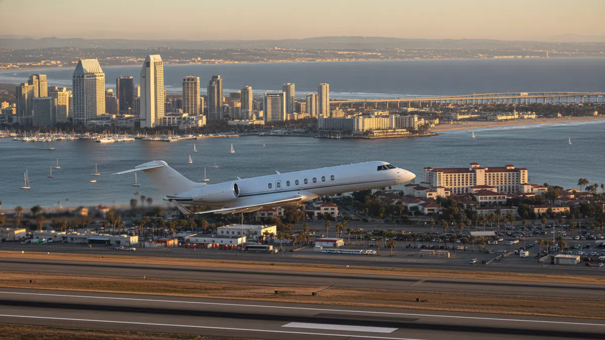 San Diego private jet charter San Diego private jet charter: business jet taking off with San Diego in the background